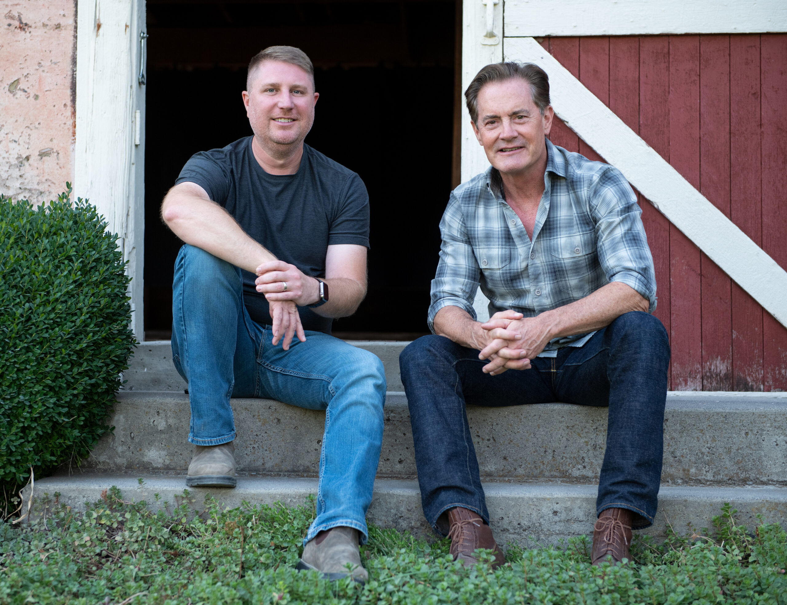 Dan and Kyle sitting in barn doorway