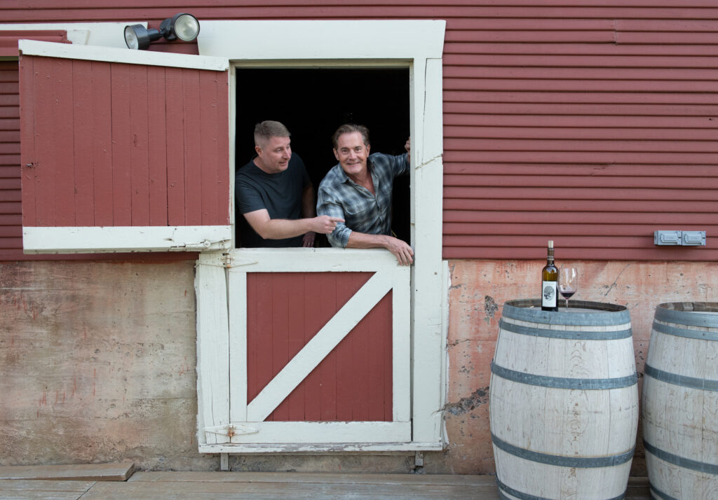 Dan and Kyle peeking out barn window