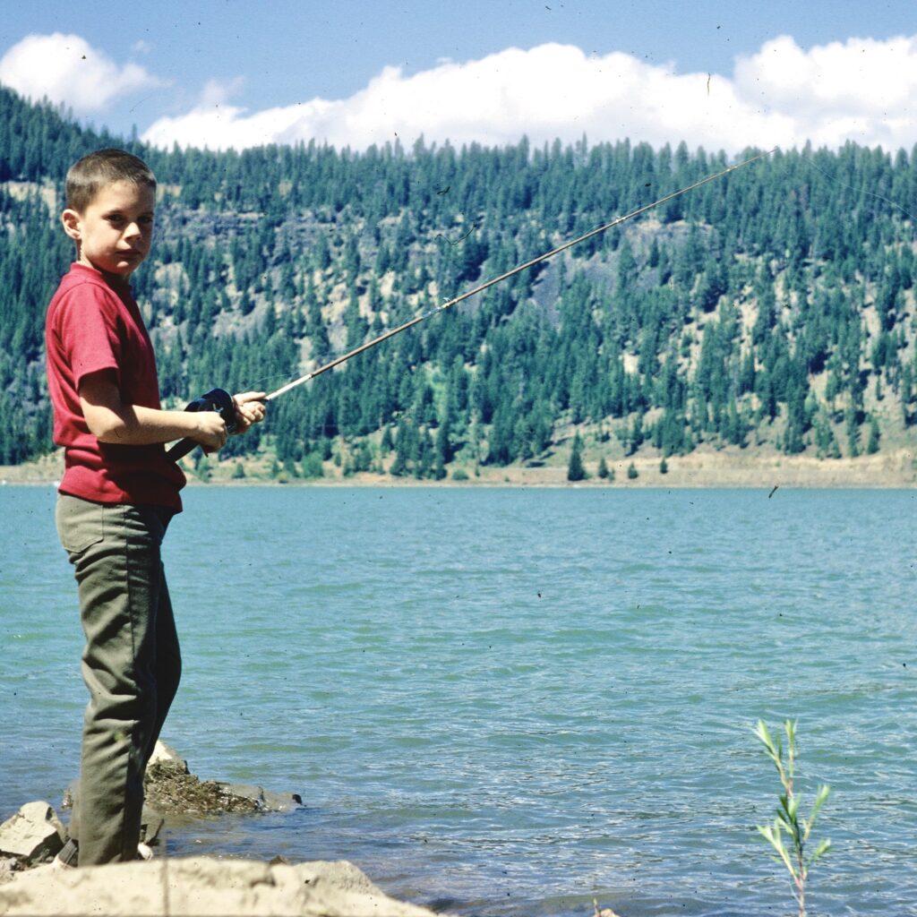Kyle as a child fishing at a lake